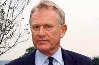 Tim Craig wearing blue suit and white t-shirt.